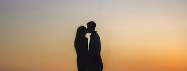 Sunset Reflections: Path to Self-Betterment Two silhouetted individuals share a peaceful moment against a golden sunset, symbolizing unity and harmony in emerging leadership.