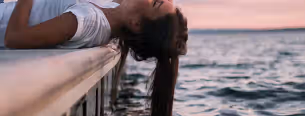 Embracing Serenity on the Path to Growth Reflecting at the water's edge, she embraces tranquility, symbolizing the calm before the growth of an emerging leader.