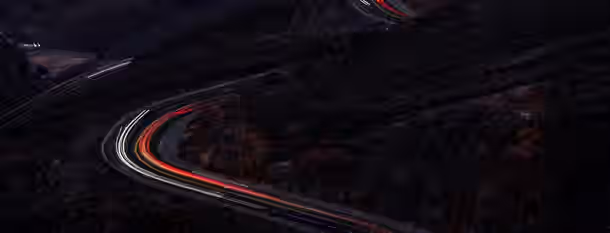 Winding Path to Self-Discovery Winding road through dark mountains, symbolizing an emerging leader's journey of growth and resilience.