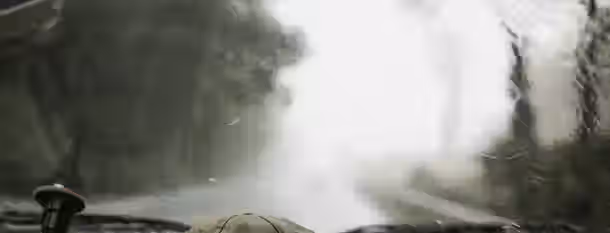 Navigating the Fog: A Leader's Path to Clarity Navigates through foggy drive, eyes on the road—a metaphor for a leader’s clear focus through uncertain times.