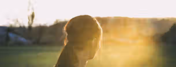 Embracing the Dawn of Personal Growth A person gazing at a sunrise, symbolizing the dawn of a journey towards growth and self-improvement.