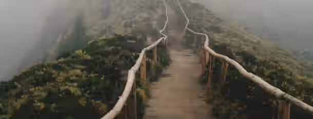 Ascending Path to Leadership Growth A foggy mountain path symbolizes the journey of an emerging leader towards self-improvement and clarity through challenges.