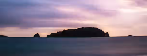 Dawn Over the Horizon: A Leader's Journey Begins A tranquil island in twilight symbolizes an emerging leader’s journey to self-improvement, poised between the horizon and the sky.