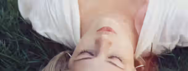 Awakening the Leader Within Lying on the grass with closed eyes, embracing inner peace and reflecting on the path to personal growth and self-discovery.