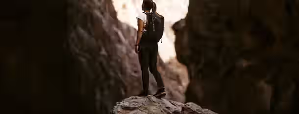 Charting the Path to Leadership Heights A lone hiker stands on a rocky peak, gazing ahead, symbolizing the emerging leader's journey toward self-improvement and growth.